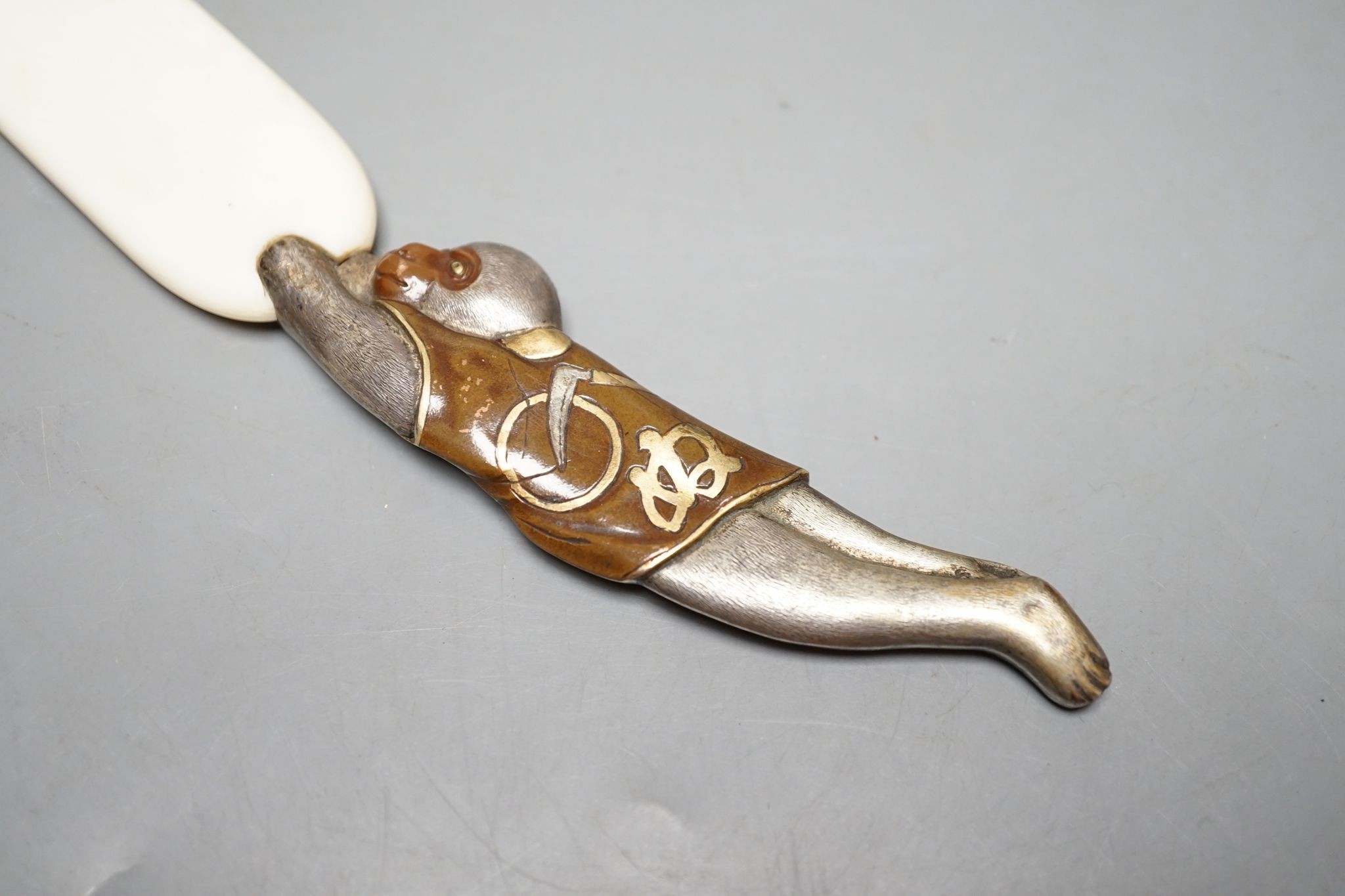 A Japanese mixed metal and ivory page turner, 38 cms long.